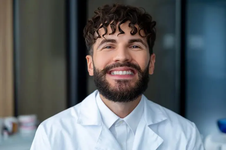 bearded man dentist clear braces showing importance dental care - Clear Braces vs Metal Braces in Kent and Sammamish, WA
